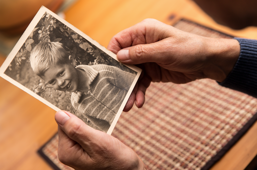 Elderly lady looking at old pictures - dementia care at home