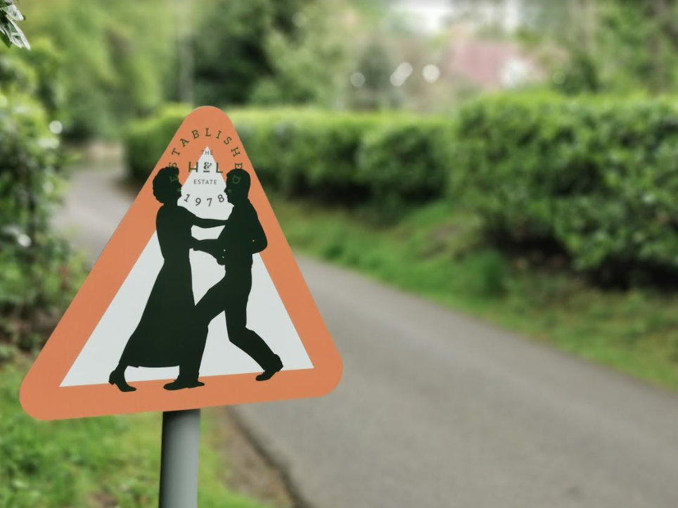 New road sign at family-centred care home in Surrey - two residents dancing